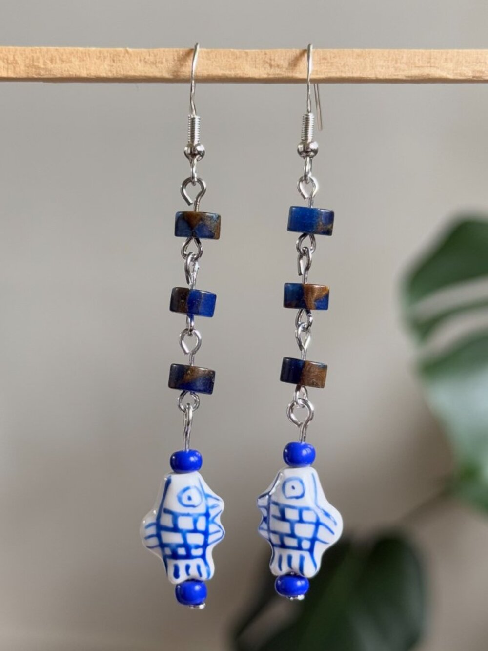 handmade earrings with navy heishi beads & dangling blue & white ceramic fish